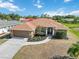 Beautiful home with well-maintained landscaping, hardscaped mulch beds, and a spacious driveway at 113 Mark Twain Ln, Rotonda West, FL 33947