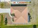 An aerial view showcases the home's roof, driveway and nearby landscaping at 113 Mark Twain Ln, Rotonda West, FL 33947