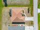 An aerial view showcases the home's roof, driveway and nearby landscaping at 113 Mark Twain Ln, Rotonda West, FL 33947