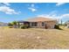 Backyard featuring a screened lanai and lush landscaping at 113 Mark Twain Ln, Rotonda West, FL 33947