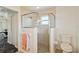 Bathroom featuring a glass shower, toilet, and towel rack with decorative towels at 113 Mark Twain Ln, Rotonda West, FL 33947