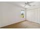 Bedroom showcasing neutral carpet, a window, closet and ceiling fan at 113 Mark Twain Ln, Rotonda West, FL 33947