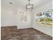 Dining room area with wood-look floors, large window, and modern chandelier at 113 Mark Twain Ln, Rotonda West, FL 33947