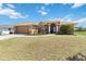 A well-maintained home featuring a two-car garage and landscaped front yard at 113 Mark Twain Ln, Rotonda West, FL 33947