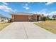 A well-maintained home featuring a two-car garage and landscaped front yard at 113 Mark Twain Ln, Rotonda West, FL 33947