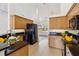 Open-concept kitchen with light wood cabinets, granite countertops, and modern appliances at 113 Mark Twain Ln, Rotonda West, FL 33947
