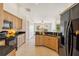 Bright kitchen featuring wood cabinets, granite countertops, and an open design at 113 Mark Twain Ln, Rotonda West, FL 33947