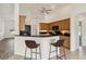 Kitchen with breakfast bar, wooden cabinets, and granite countertops at 113 Mark Twain Ln, Rotonda West, FL 33947