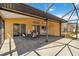 Covered lanai with a dining table and views of the backyard at 113 Mark Twain Ln, Rotonda West, FL 33947