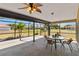 Outdoor lanai with dining area, ceiling fan, and view of surrounding yard at 113 Mark Twain Ln, Rotonda West, FL 33947