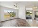 Open living space featuring wood-look flooring and a screened-in lanai at 113 Mark Twain Ln, Rotonda West, FL 33947