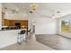 Open-concept living room showcases vaulted ceilings, ceiling fans, and seamless flow to the kitchen with bar seating at 113 Mark Twain Ln, Rotonda West, FL 33947