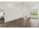 Bright living room with wood-look floors, large windows, and recessed lighting at 113 Mark Twain Ln, Rotonda West, FL 33947
