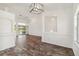 Open living room with stylish floors, arched entryways, and access to the lanai at 113 Mark Twain Ln, Rotonda West, FL 33947