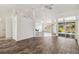 Bright open floor plan with wood-look flooring, kitchen bar, and access to the lanai at 113 Mark Twain Ln, Rotonda West, FL 33947