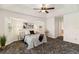 Comfortable main bedroom features a ceiling fan and natural light from windows, creating a cozy retreat at 113 Mark Twain Ln, Rotonda West, FL 33947