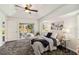 Inviting main bedroom with neutral decor, ceiling fan, and access to the lanai for relaxation at 113 Mark Twain Ln, Rotonda West, FL 33947