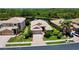 Aerial view of home with manicured lawns, beautiful landscaping, and easy access to a peaceful pond at 11437 Dancing River Dr, Venice, FL 34292