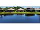 Picturesque backyard with a serene pond view and lush green lawns, perfect for outdoor enjoyment at 11437 Dancing River Dr, Venice, FL 34292