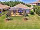 This home has a screened lanai with outdoor furniture and a green lawn at 11437 Dancing River Dr, Venice, FL 34292