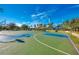 Exterior shot of a community basketball court with colorful markings and basketball hoops at 11437 Dancing River Dr, Venice, FL 34292