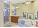 Bathroom boasting a soaking tub, glass shower, and double sink vanity at 11437 Dancing River Dr, Venice, FL 34292