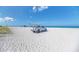 Lifeguard truck on a white sand beach, under a clear blue sky, and calm ocean at 11437 Dancing River Dr, Venice, FL 34292