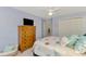 The bedroom has soft blue walls and a ceiling fan at 11437 Dancing River Dr, Venice, FL 34292