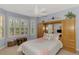 Cozy bedroom featuring a built-in wardrobe and sunlit windows with lush outdoor views at 11437 Dancing River Dr, Venice, FL 34292
