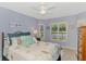 The bedroom is decorated with a coastal theme and soft colors at 11437 Dancing River Dr, Venice, FL 34292