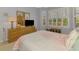Bright bedroom featuring plantation shutters, a wooden dresser, and comfortable bedding at 11437 Dancing River Dr, Venice, FL 34292