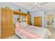 Bedroom showing a built-in wardrobe with mirrors and an attached bathroom at 11437 Dancing River Dr, Venice, FL 34292