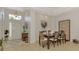Formal dining room with modern light fixture, large windows, and a view into the foyer creating an elegant space at 11437 Dancing River Dr, Venice, FL 34292
