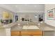Kitchen bar overlooks open living spaces, and features a stainless steel dishwasher at 11437 Dancing River Dr, Venice, FL 34292