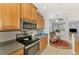 Bright kitchen features stainless steel appliances, wood cabinets, and a breakfast nook at 11437 Dancing River Dr, Venice, FL 34292