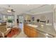 Kitchen bar with seating provides an open view of the dining area, enhancing the home's layout at 11437 Dancing River Dr, Venice, FL 34292