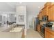 Well-lit kitchen with stainless steel appliances and wood cabinetry overlooks an open-concept dining area at 11437 Dancing River Dr, Venice, FL 34292