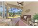 Inviting screened lanai with comfortable seating, ceiling fan, and serene water views at 11437 Dancing River Dr, Venice, FL 34292