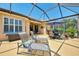 Relaxing screened lanai with lounge chairs, dining set, and peaceful outdoor views at 11437 Dancing River Dr, Venice, FL 34292