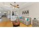 Open-concept living room offers tray ceiling, fan, and seamless transition to the kitchen at 11437 Dancing River Dr, Venice, FL 34292