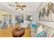 Bright living room features modern furniture, ceiling fan, and access to outdoor patio at 11437 Dancing River Dr, Venice, FL 34292