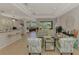 Bright and airy living room with large windows and neutral tones, perfect for relaxation and entertaining guests at 11437 Dancing River Dr, Venice, FL 34292
