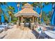 Outdoor kitchen with a built-in grill and seating area, perfect for entertaining guests at 11437 Dancing River Dr, Venice, FL 34292