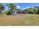 A backyard featuring a large yard and covered patio area at 11455 Fort Lauderdale Pl, Venice, FL 34293