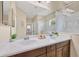 Bathroom featuring double sinks, granite countertops, and a large mirror with a view of the shower at 11455 Fort Lauderdale Pl, Venice, FL 34293