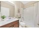 Well lit bathroom with a shower/tub combo, white cabinets, and neutral paint at 11455 Fort Lauderdale Pl, Venice, FL 34293