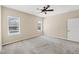 Light-filled bedroom featuring carpeted floors and windows offering views of the outdoor pool at 11455 Fort Lauderdale Pl, Venice, FL 34293