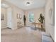 Bright home office featuring a wooden desk, stylish chair, ample natural light, and neutral decor at 11455 Fort Lauderdale Pl, Venice, FL 34293