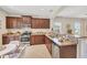 Well-appointed kitchen with granite countertops, stainless steel appliances, and dark wood cabinetry at 11455 Fort Lauderdale Pl, Venice, FL 34293