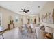Inviting living room with neutral walls, tile flooring, ceiling fan, and a seamless flow to the kitchen at 11455 Fort Lauderdale Pl, Venice, FL 34293
